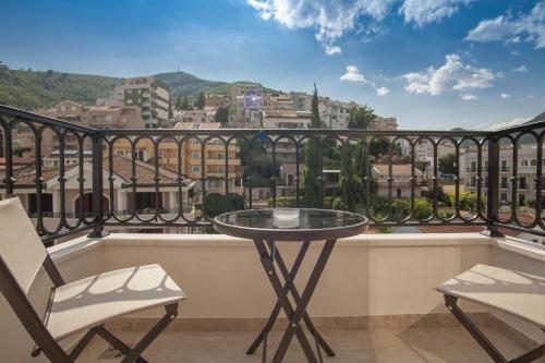 a table and two chairs on a balcony with a view at Hotel Villa Gracia in Budva