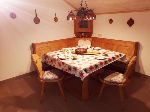 a dining room table with a tablecloth on it at Ferienwohnung - Haus Monika in Philippsreut