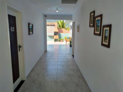 a hallway with white walls and a tile floor at Pousada Souza in Florianópolis