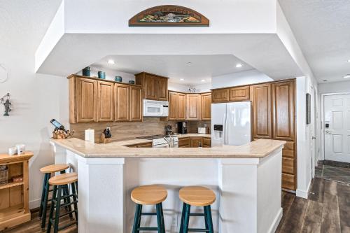 a kitchen with wooden cabinets and a counter with stools at Astounding Arrow Point (F-101) in Harrison