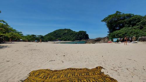 a view of a beach with a large object in the sand at Flats Alto das Pedras in Trindade