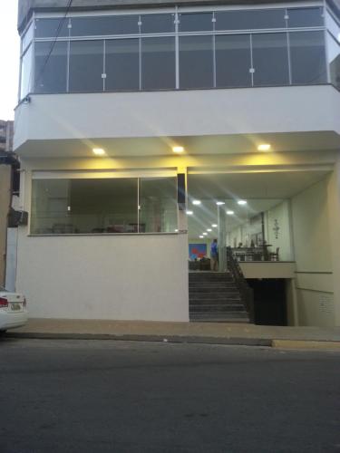 a building with a large window on the side of it at Hotel Maria da Fé in Aparecida