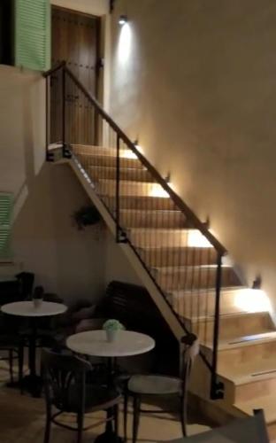 a stairway with two tables and chairs and a staircase at Casal de Petra - Rooms & Pool by My Rooms Hotels TI in Petra