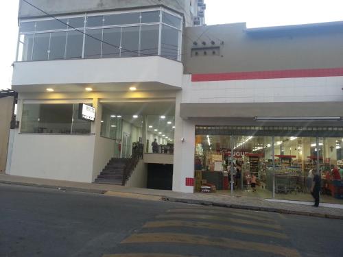 a store front of a building with people in it at Hotel Maria da Fé in Aparecida