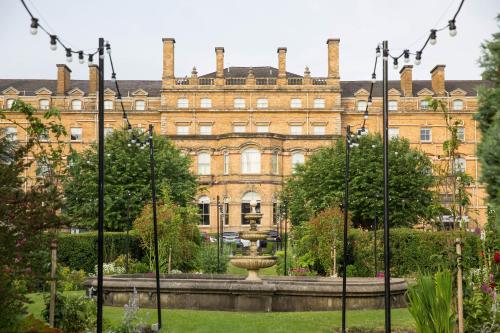 an old building with a fountain in front of it at The Milner York in York