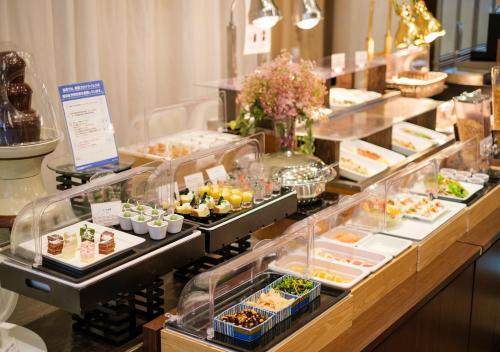 a buffet line with many different types of food at APA Hotel Kanazawa Ekimae in Kanazawa