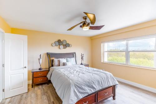 a bedroom with a bed and a ceiling fan at La Brisa 108N in Key West
