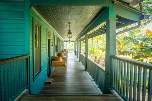 an empty porch of a house with blueiding at Lumeria Maui, Educational Retreat Center in Makawao