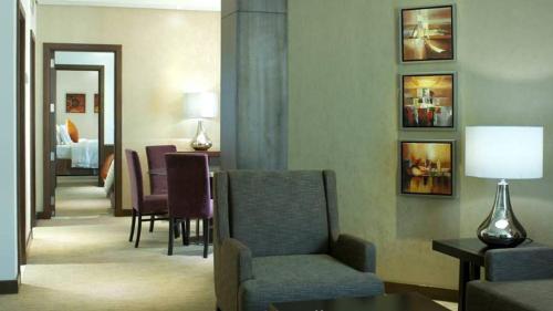 a living room with a couch and a chair and a table at Crowne Plaza Madinah by IHG in Al Madinah