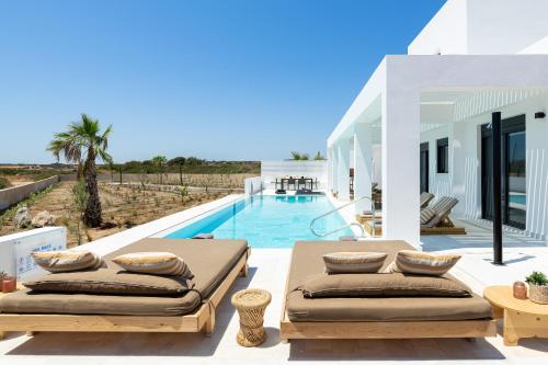 a villa with a swimming pool with two beds at Seasand Villa in Lachania