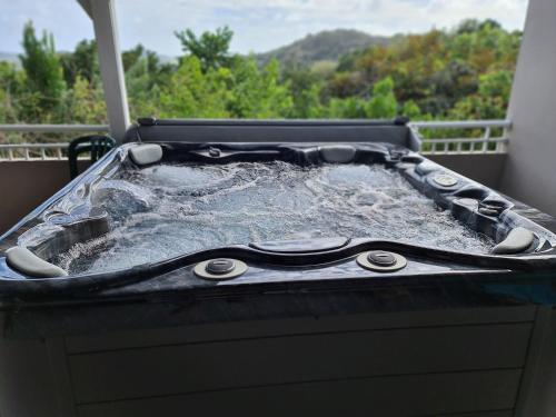 a hot tub sitting on top of a balcony at Residence Can' Hibiscus in Le Marin