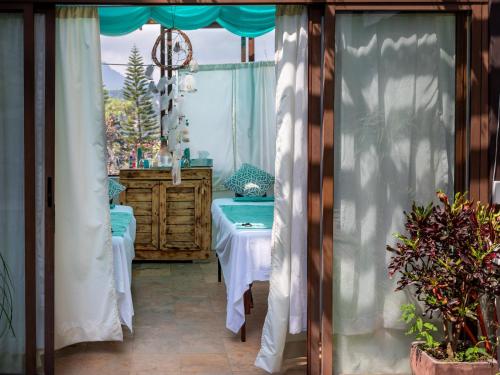 a room with a table and a window with curtains at Hotel Santa Rosa in Valle de Bravo