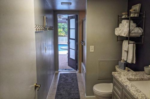 a bathroom with a toilet and a door to a yard at The Max in Cape Coral