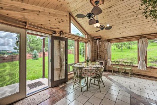 a dining room with a table and chairs and windows at Valley Cloudcroft Hideaway Less Than 8 Mi to Town! in Cloudcroft