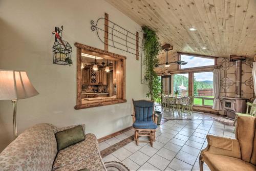 a living room with a couch and a mirror at Valley Cloudcroft Hideaway Less Than 8 Mi to Town! in Cloudcroft