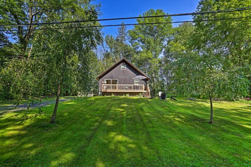 a large house on a green field with trees at Deck and Gas Grill Modern East Stroudsburg Home! in East Stroudsburg
