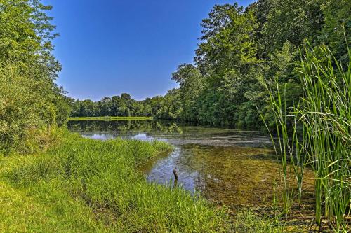 a river with grass and trees on the side at Deck and Gas Grill Modern East Stroudsburg Home! in East Stroudsburg