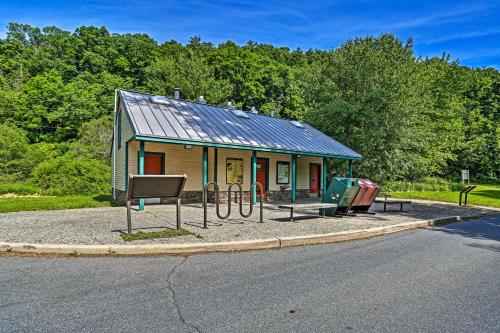 a small building with a metal roof next to a street at Deck and Gas Grill Modern East Stroudsburg Home! in East Stroudsburg