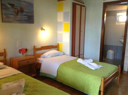 a hotel room with two beds with towels on them at Studios LaLu in Skiathos