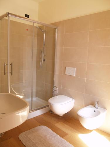 a bathroom with a shower and a toilet and a sink at Casa Botta - Luino Lago Maggiore in Luino