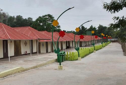 a row of street lights with red and yellow flowers at Praveg Tent City Narmada, Statue of Unity in Kevadia