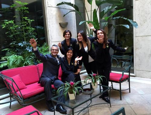 a group of women in suits sitting on a pink couch at Hotel dei Mellini in Rome