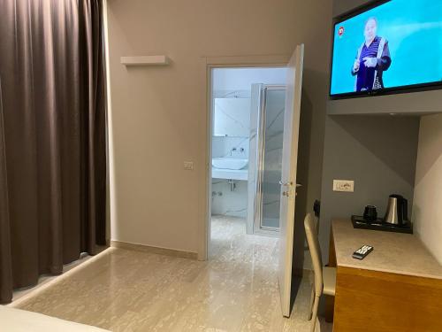 a room with a flat screen tv on the wall at Oasi Village Hotel in Milan