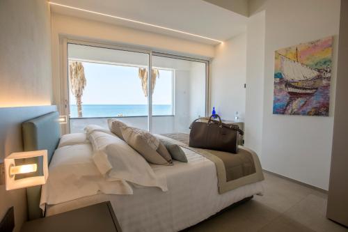 a bedroom with a bed with a view of the ocean at VistAmare Luxury Retreat in Sestri Levante