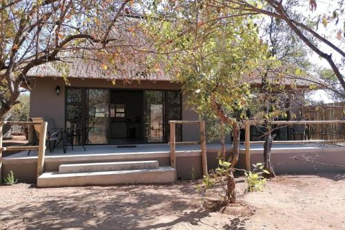 a building with a porch and stairs in front at Amukela Kaya in Hoedspruit