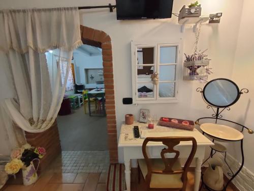 um quarto com um toucador, uma mesa e um espelho em Lo scrigno di Simon em Senigallia