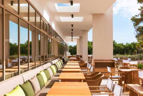 a row of tables and chairs in a restaurant at Radisson Blu Resort Al Hoceima in Al Hoceïma