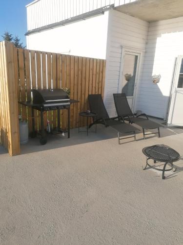 a patio with a piano and a table and a keyboard at Seaview apartment Karmøy in Sæveland
