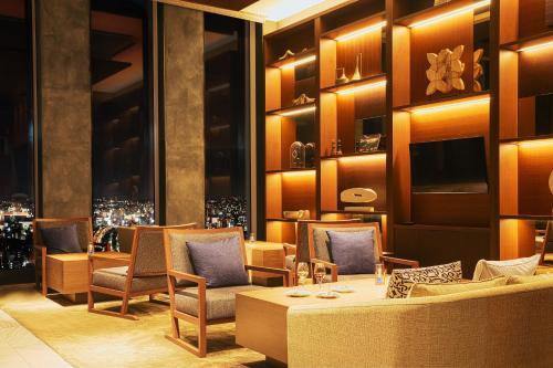 a restaurant with chairs and a table and a window at Nagoya Prince Hotel Sky Tower in Nagoya