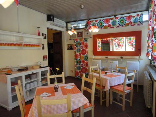 a kitchen and dining room with tables and chairs at Hostel Pisa Tower in Pisa