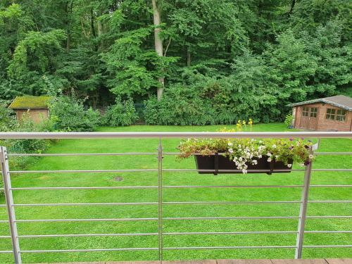 a fence with a pot of flowers on it at Ferienwohnung an der Hasenburg in Lüneburg