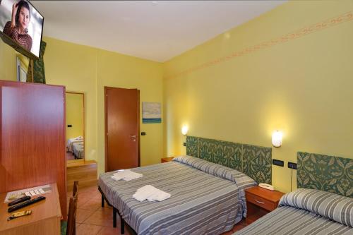 Postel nebo postele na pokoji v ubytování Hotel Villa Colombo