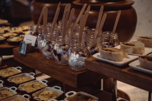 a display of desserts in jars on a table at Radisson Blu Resort Visakhapatnam in Visakhapatnam