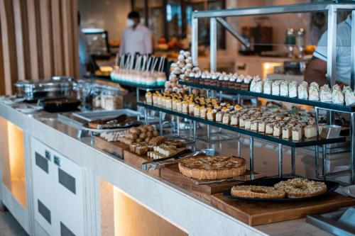 a buffet line with many different types of food on display at Radisson Blu Resort Visakhapatnam in Visakhapatnam