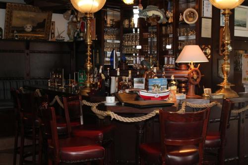 a bar with chairs and a table with a lamp at Hotel Gastmahl des Meeres in Sassnitz