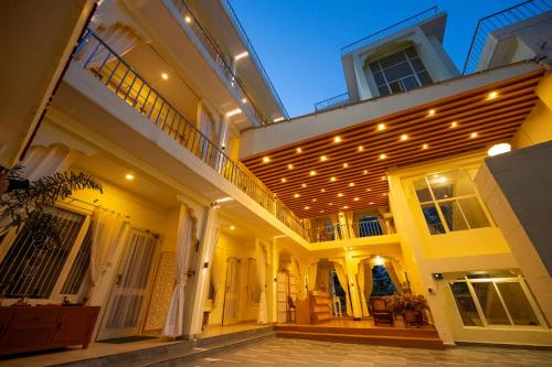 a building with a bunch of lights on it at Maharishi Ayurveda-Boutique Wellness Retreat in Rishīkesh