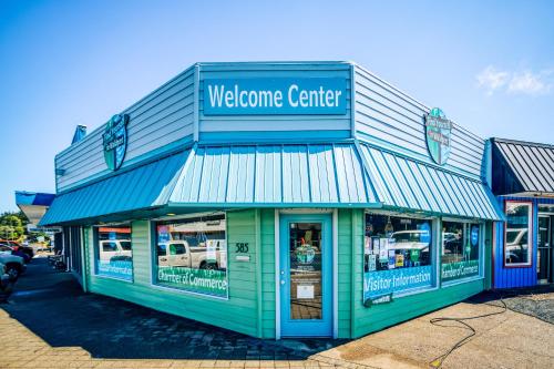 a welcome center sign on the front of a store at Catamaran Cottage in Waldport