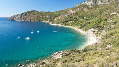 a view of a beach with boats in the water at Appartamento il Mulino in Orbetello