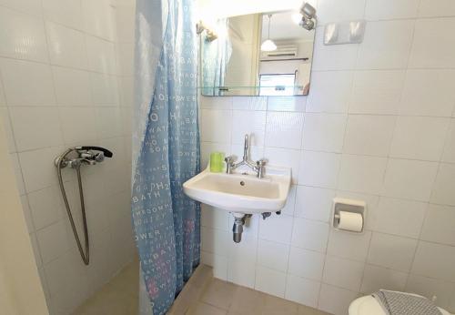 a bathroom with a sink and a shower at Dionysios Studios in Skala