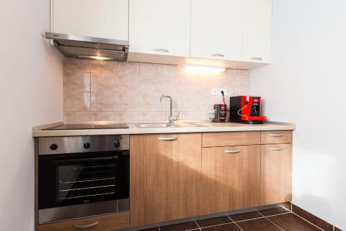 a kitchen with a sink and a stove at Hostel Sunset in Zadar