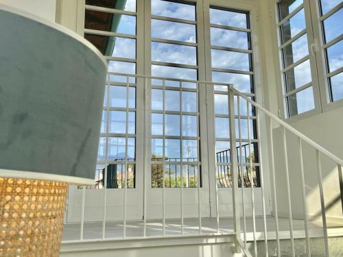 a staircase in a building with large windows at Luxury Home Paradise View in Forte dei Marmi