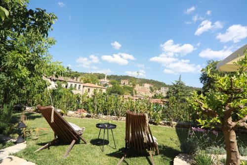 two chairs and a table in a yard at Perlacia Hotel Adatepe in Adatepe
