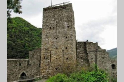 an old castle with a tower on top of it at Alloggio per Vacanze a Isolabona in Isolabona