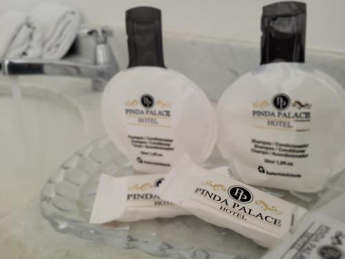 two bottles of soap sitting on top of a sink at Pinda Palace Hotel in Pindamonhangaba