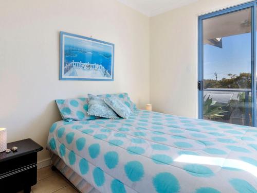 a bedroom with a bed and a large window at Nautilus 6 Beach Front Bliss in Hawks Nest