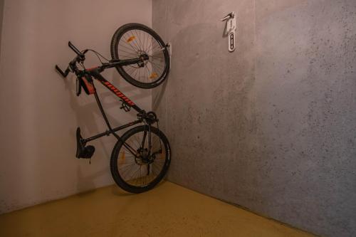 a bike hanging on a wall in a room at Horský apartmán Nový Javor - s možností využití wellness in Železná Ruda